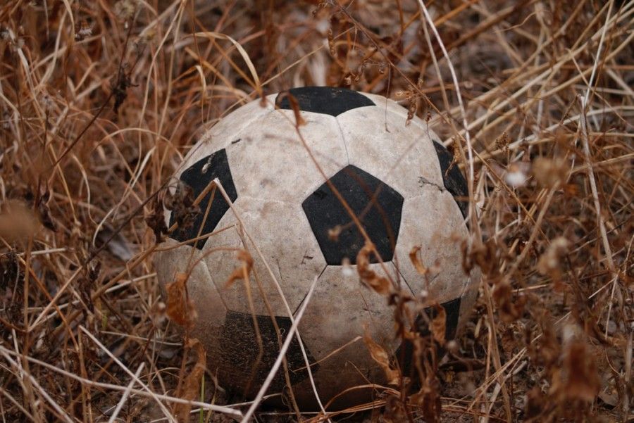 black-and-white-soccer-ball-in-brown-field