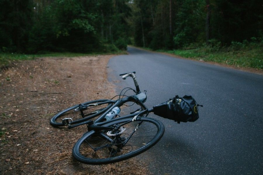black-road-bike-lying-on-asphalt-road-during-daytime