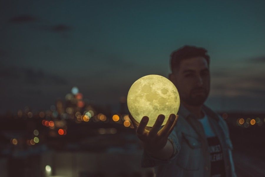 man-holding-moon-lamp