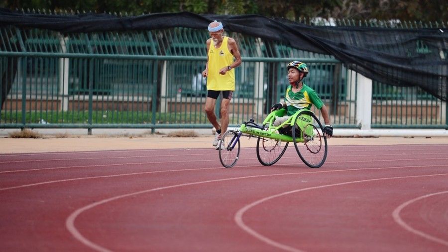 man-using-green-wheelchair-for-walking