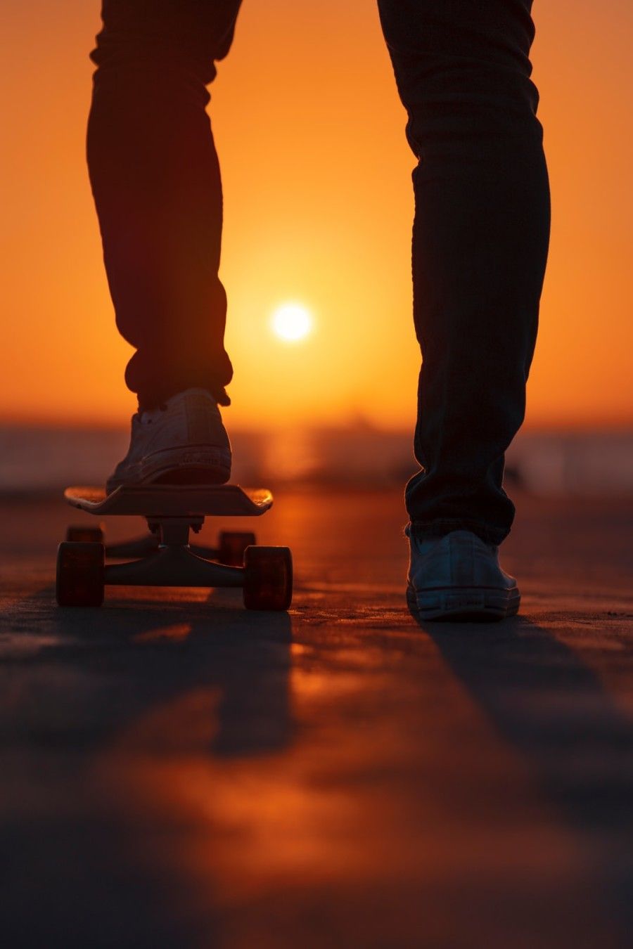 selective-focus-photo-of-person-standing-on-skateboard-during-golden-hour