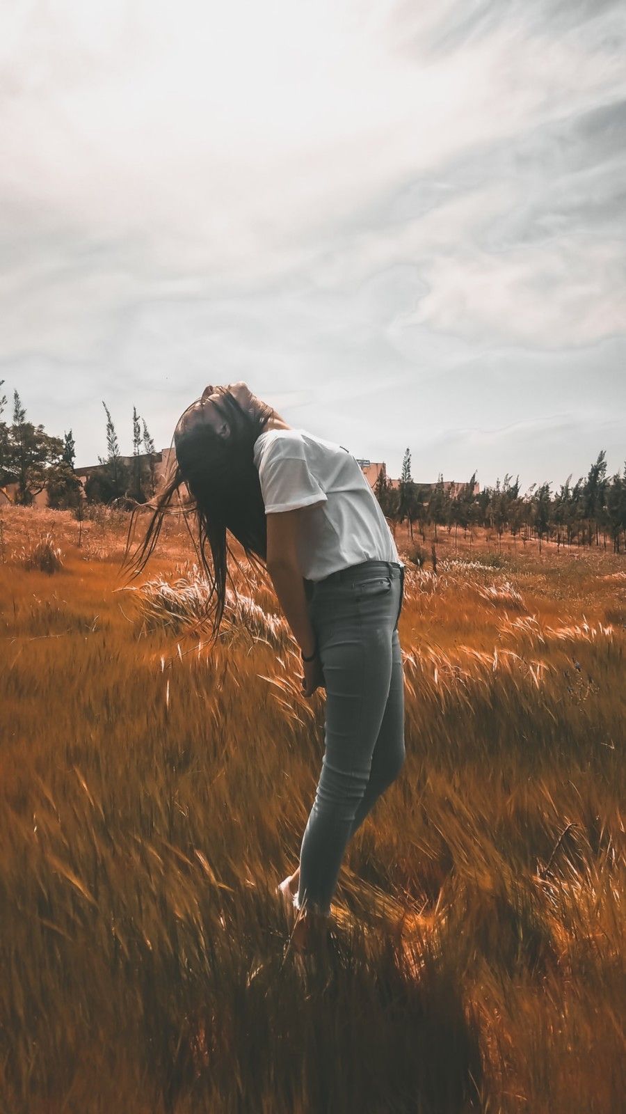 woman-standing-on-brown-grass-field