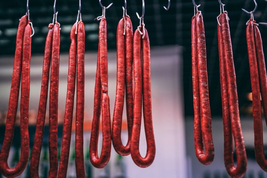 long-red-meat-hanging-from-hooks