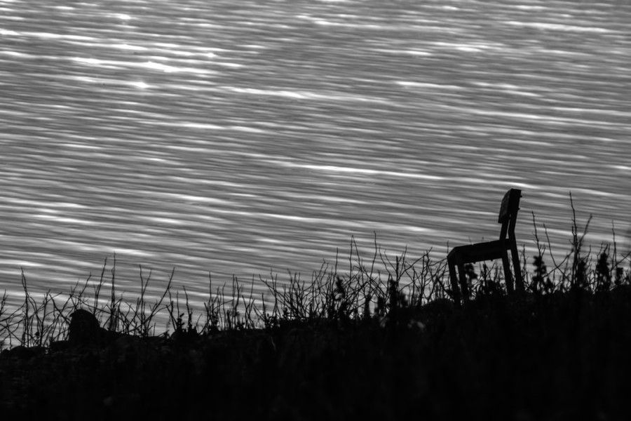silhouette-photography-of-chair-near-ocean
