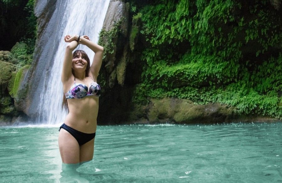 woman-in-black-and-white-bikini-near-waterfalls-during-daytime