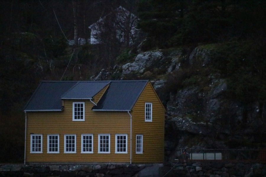 white-and-brown-wooden-house-on-rock