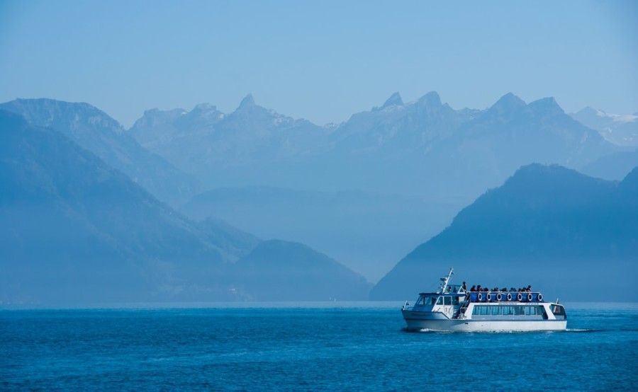 white-ferry-sailing-at-sea-near-mountainous-shore