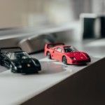 two-black-and-red-sprots-car-toys-near-windwo